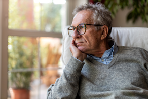 Life Assure Senior Woman Sitting In Chair And Laughing With Caregiver Nurse Blog